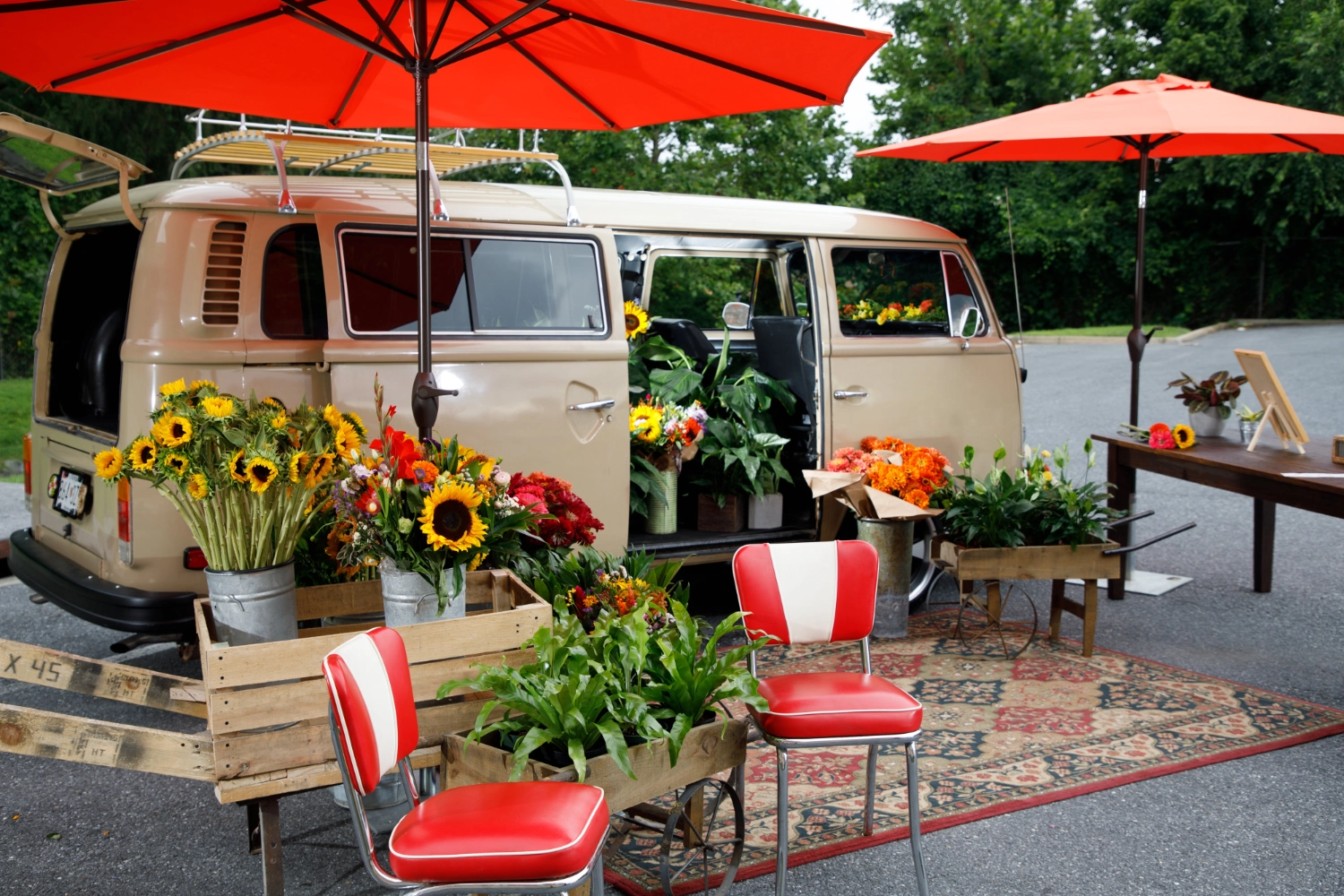 The VW Blooming Bus pop-up styled with seating and buckets of blooms